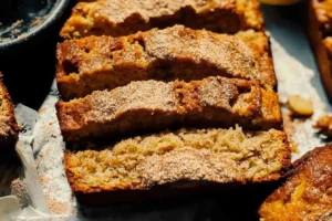 Sliced cinnamon banana bread with a golden crust and cinnamon sugar topping.