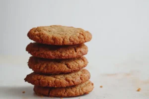 Stack of crispy graham cracker cookies on a light background.