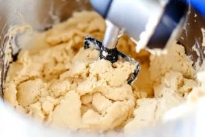 Vanilla cookie dough being mixed in a stand mixer.