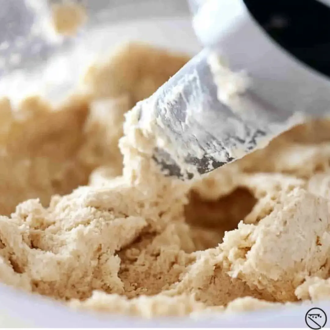 Creamy Cookie Dough for M&M Cookie Bars Soft cookie dough being mixed in a stand mixer, ready for making M&M cookie bars